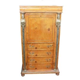 Vintage French Empire Style Maple Secretaire a' Abattant: A vintage French empire style maple Secretaire a’ Abattant. The case features two female bust ormolu mounts on marble columns. The columns are lined with twisted wire and lead to the feet. The opened desk top has a leather insert with a gold stenciled border, six small drawers, and an arched mirror. Below are four drawers with silver-tone acantha leaf pulls. The piece has a bottom ledge and stands on bun feet. Unmarked.