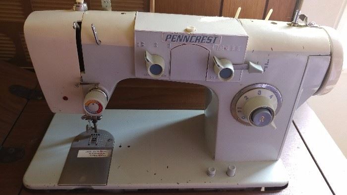 Penncrest sewing machine in a cabinet, has accessories.