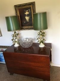 A gorgeous drop leaf flame mahogany gate leg table, a large ABP punch bowl and pair of metal birds and floral lamps