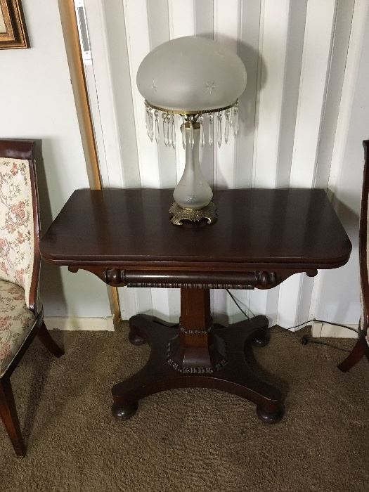 Antique game table and frosted parlor lamp with crystals