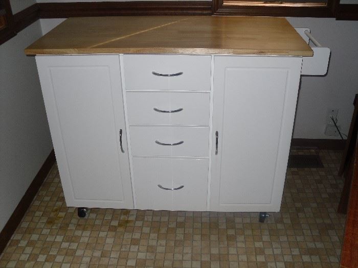 Your kitchen can have additional prep space and storage with this multifunctional kitchen island cart!  An enclosed shelved storage area and towel rack with 4 drawers for more storage. The beautiful and spacious prep surface is complimented by the white cabinet.  Store your mixing bowls, cutting boards, cookbooks, knives.... Makes a great Coffee Bar!