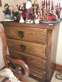 nice dresser with collection of Santa's