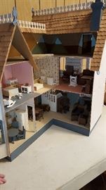 Hand crafted doll house with hand built miniature furniture.