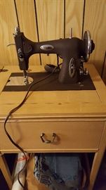 Antique White cast iron sewing machine in cabinet
