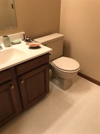 Nice dark wood bathroom vanity and toilet!