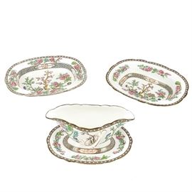Coalport "Indian Tree Multicolor" Serving Pieces: A grouping of three pieces in the Coalport Indian Tree Multicolor pattern. The two oval vegetable bowls and sauce boat with an attached underplate feature the Indian Tree Multicolor pattern with scalloped edges, floral designs, and a tree to the center. The undersides are stamped with a royal crown logo and “England, Coalport A.D. 1750”.