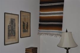 Framed artwork, large Mexican rug, ornate floor lamp with shade