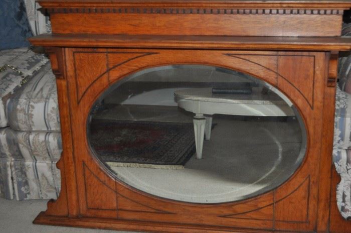 Antique oak framed oval beveled mirror, dentil molding