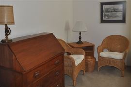 Mid-1800s American walnut slant-front bureau desk, wicker chairs, covered basket, lamp