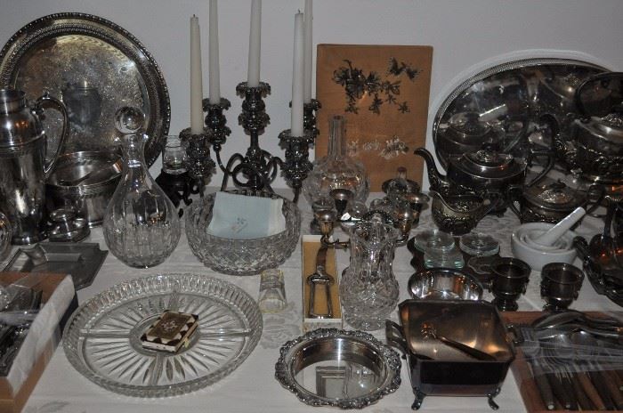 Lunt silver plate pair of ornate candlesticks, Lunt silver plate ornate oval platter, Monterey branded table, crystal decanters, large silver plate round tray,  Apollo Loraline ice bucket w/tongs, Apollo Loraline cocktail shaker, Wilcox Meriden elaborate quadruple plate 4-arm 5-candle candelabra, crystal bowl, Mexican silver plate candleholders, Wallace silver plate wine bottle holder, Lunt silver plate bowl, square silver plate dish, Wilcox Meriden ornate silver plate bowl with cherry relief, large oval Sheffield silver plate tray with galley, IFS Israel Freeman & Son 6-piece tea and coffee service, Dansk Fjord teak stainless flatware 36 pieces
