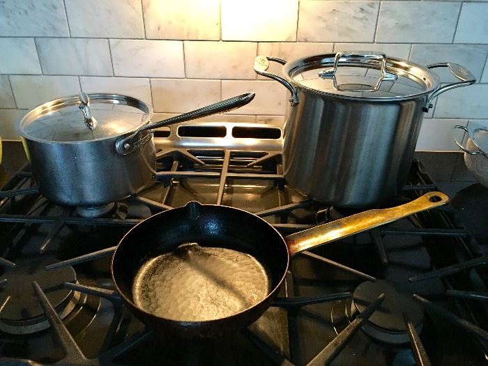 All Clad (background) and heavy duty "seasoned" sauce pan