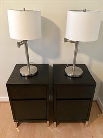 Two "West Elm" nightstands, each with a single drawer and cabinet.  Two swing arm lamps and shades.