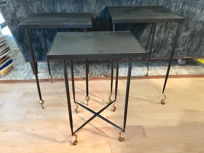 Set of 3 nesting metal side tables in a black finish, with 'curly cue' feet in gold.