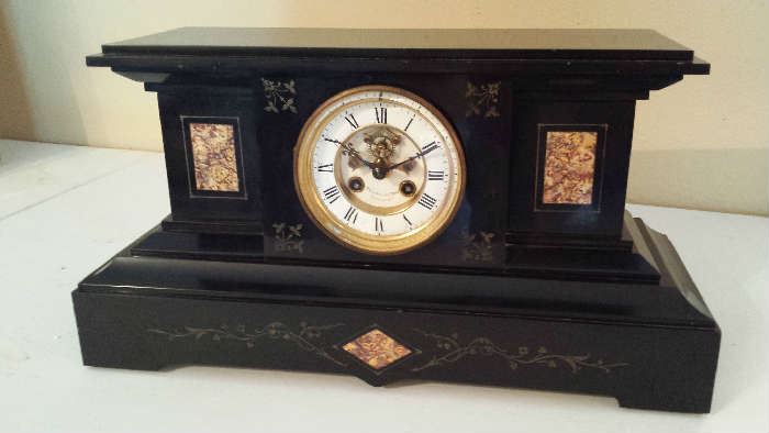 Ebonized stone clock with marble insets. Dial is marked  Becker & Lathrop, Syracuse, NY