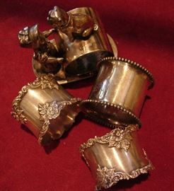 Figural napkin ring and three sterling napkin rings