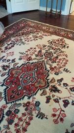 Note the light background on this hand woven wool 8 x 10 rug from Iran
