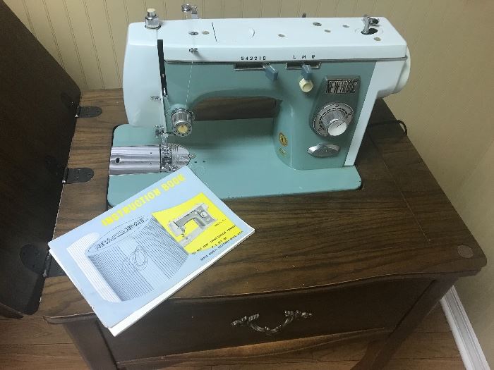 Nice aqua colored sewing machine with original instructions
