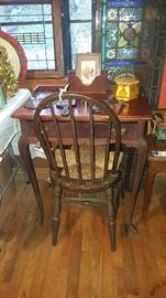 Desk, chair, antique stained glass panel 