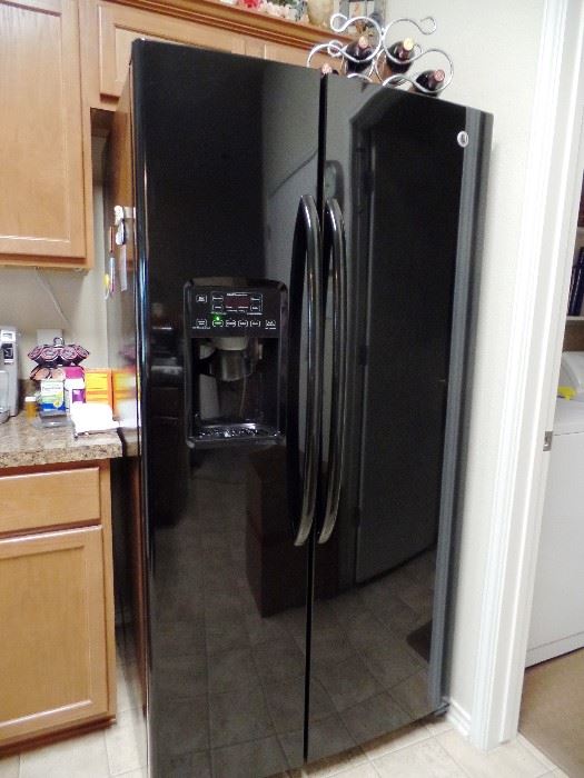 Sleek black refrigerator with water/ice dispenser