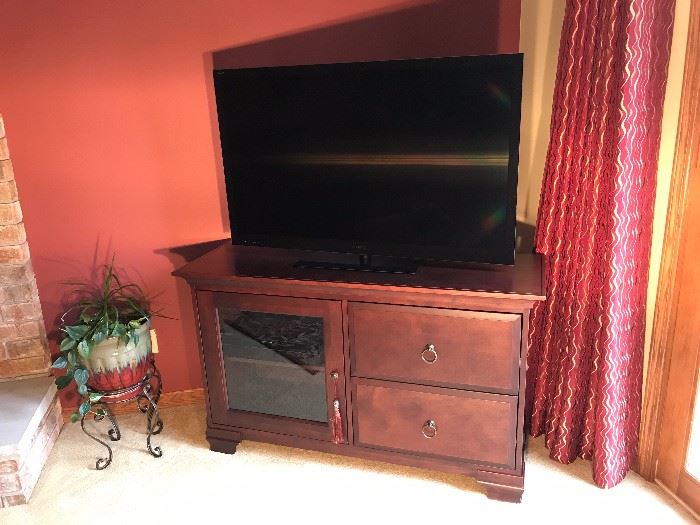 Large flat screen TV with entertainment center cabinet