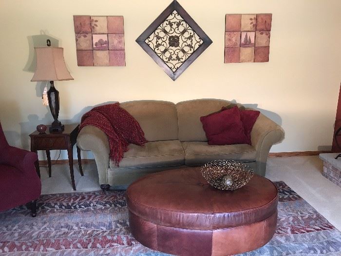 Quality love seat and round coffee table; lamps and tables and wall decor