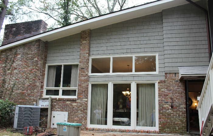 The back side of the house showing windows into the dining room.