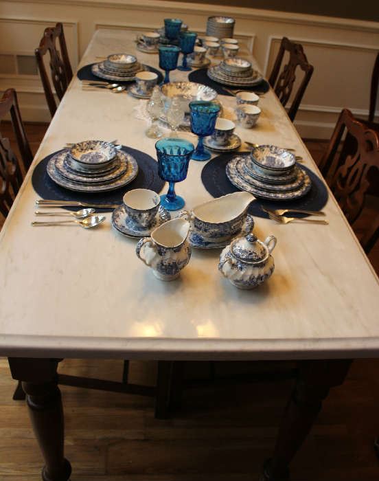 Close-up of the table and china "Coaching Scene" by Johnson Brothers, blue and white, 12 place setting with serving pieces. 