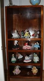 Book case with a collection of collectible dolls.
