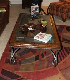 The metal and glass coffee table.