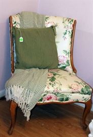 The chair with the throw and decorative pillow.