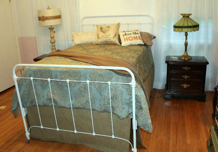 The white metal bed with the beautiful duvet cover and the handmade dust ruffle.