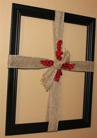 The cross out of burlap ribbon and red berries.