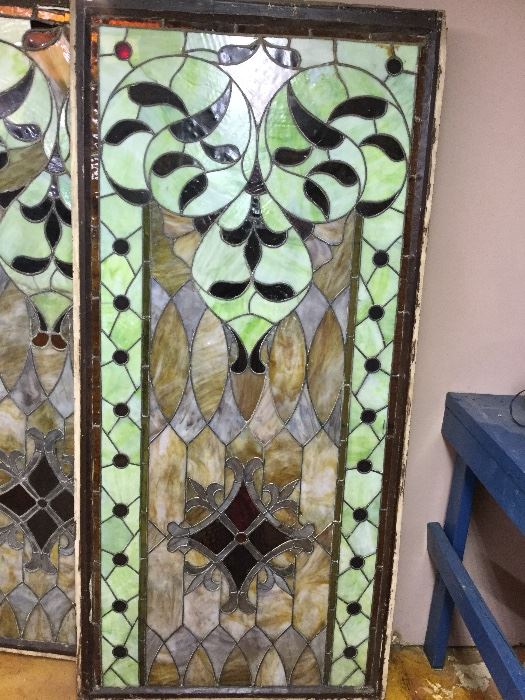 Antique stained glass window in wooden casing   Approximately 72"x 34". One of a pair. The second window requires some repair 