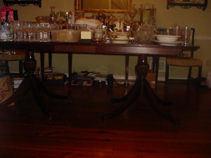 This is a fine antique table, double pedestal, made by Baker almost 100 years ago. Comes with 6 chairs, and compatible buffet
