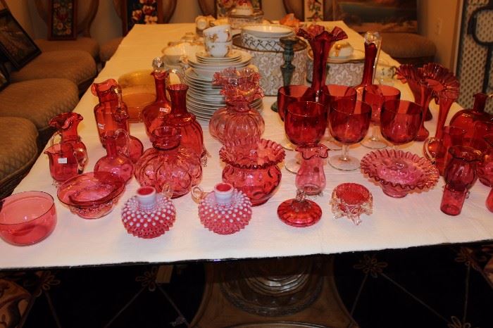 Large amount of cranberry glass. Bud vases, creamers, flared vases, punch cups, beakers, pitchers, pickle castor, carafe, wine cruet, ruffled neck vase, toothpick holder, rose bowl, dish with ruffled edge, finger bowl.