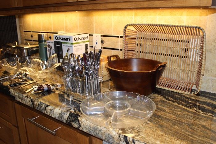 Stainless flatware, salad bowls, Cuisinart coffee maker, thermos flask, Pyrex serving trays.