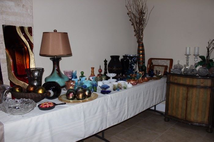 Tables of Depression glass, cut glass, crystal, candle sticks. Decorative balls and vases.
