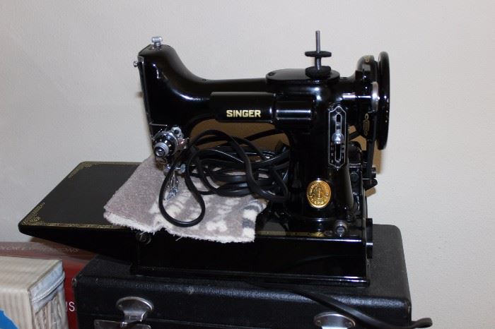 Antique Singer sewing machine, like new, with carrying case.