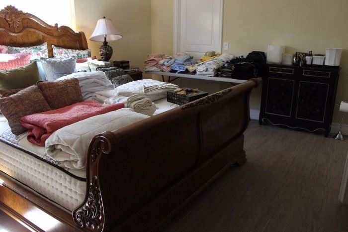 King size sleigh bed and assorted linens, comforters and bed linens.
