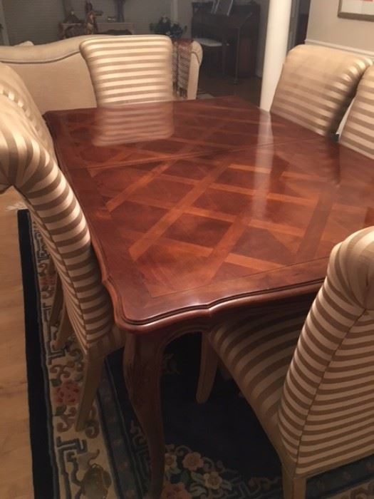 Drexel Heritage dining room table with six fabric chairs.  Two leaves and custom pad to fit curves and contour of table edge.