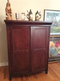Very nice TV entertainment center. German beer steins