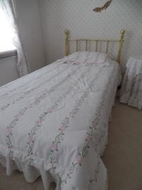 Matching brass twin beds and bedding