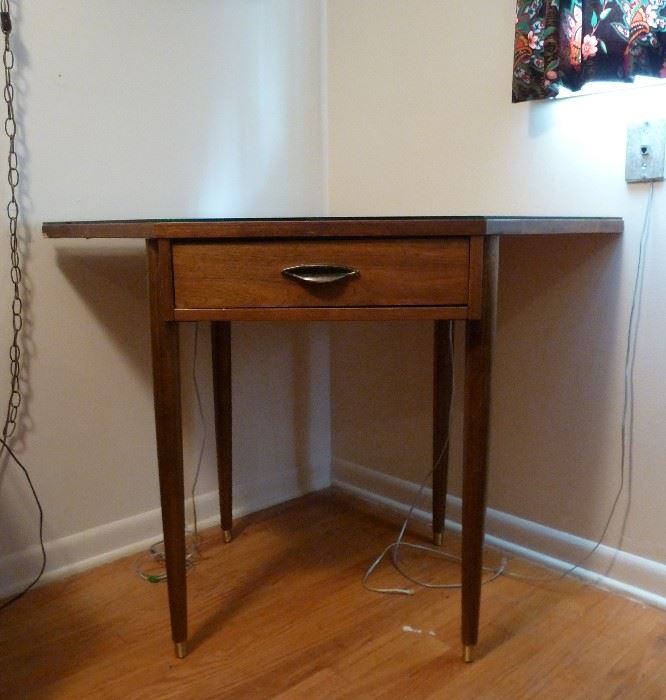 Mid Century Modern corner table, pencil legs, one drawer, glass top.