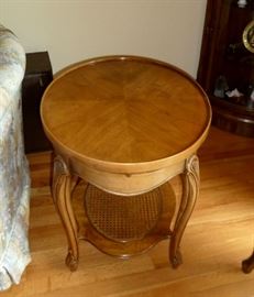 Pair of solid wood end tables with pull-out tray and caned bottom shelf.  20" x 25"