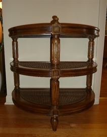 Half round 3-tier table, solid wood, beveled glass top insert, 2 caned shelves.  27" wide, 16" deep, 25" tall.