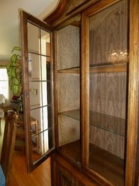 Solid wood china cabinet, by Townhouse Interiors, 2 glass doors, brass fretwork inserts, lighted.  Bottom storage of 3 drawers, 2 doors, brass hardware.