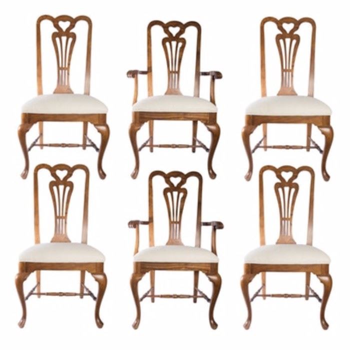 Queen Anne Style Dining Chairs: A set of six Queen Anne style dining chairs. The chairs features oak frames with carved back splats with a heart shape to the top and cream upholstered seats. The chairs rest on cabriole style front legs with turned spacers. The set includes four side chairs with two arm chairs.