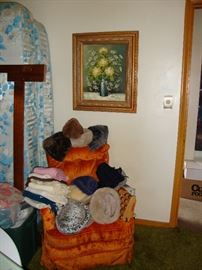 Upholstered chair; framed floral painting; scarves
