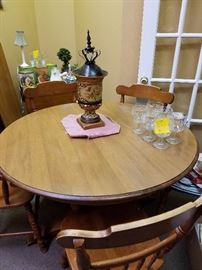 Vintage round table with 5 chairs and two leaves.