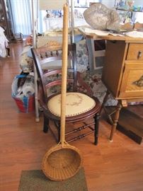 Antique needle point chair with a collection basket out of a Catholic church